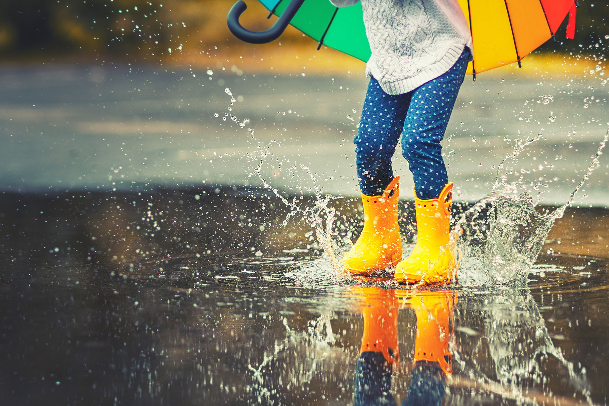 Kid jumping in Spring puddle